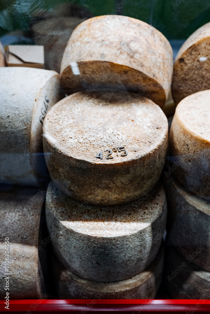 An assortment of cheese varieties is artistically stacked, creating a visually appealing display that highlights their distinct shapes and textures, engaging for observers An assortment of cheese varieties is artistically stacked, creating a visually appealing display that highlights their distinct shapes and textures, engaging for observers