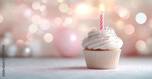Delicate cupcake with a candle and sprinkles in a softly lit setting during a...