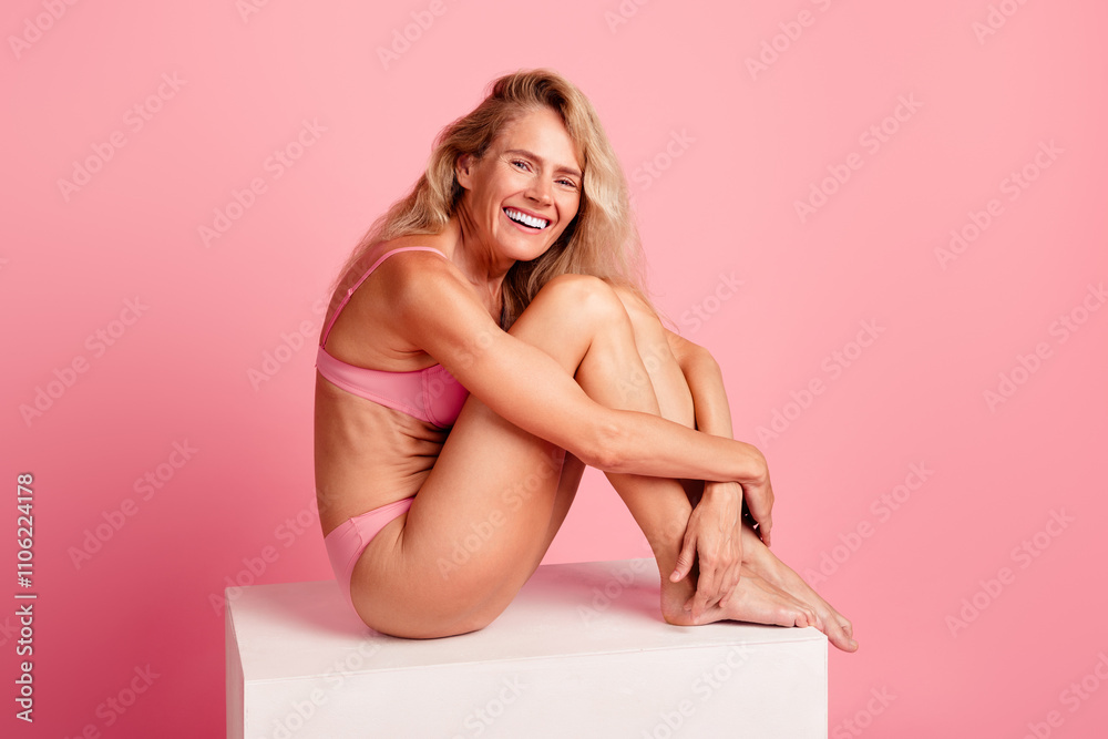 Photo of adorable charming woman wear stylish lingerie sit cube hug knees isolated on pink color background Photo of adorable charming woman wear stylish lingerie sit cube hug knees isolated on pink color background