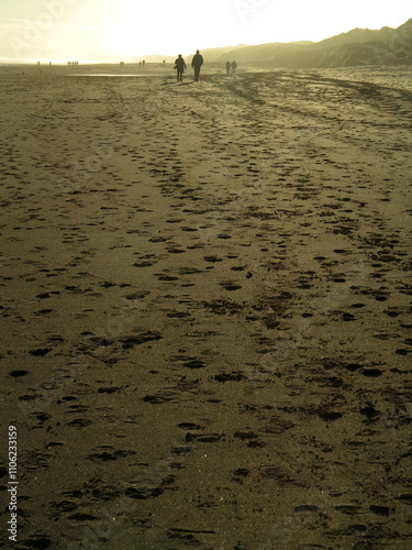 Sandy beach and walkers in the distance with back light in Balmedie - Aberdeenshire - Scotland - UK photo