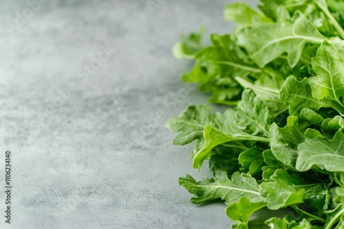 Fresh kale leaves arranged on a gray background showcasing vibrant green colo...