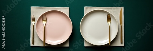 Elegant table setting with gold cutlery and simple dishes on dark green backg...