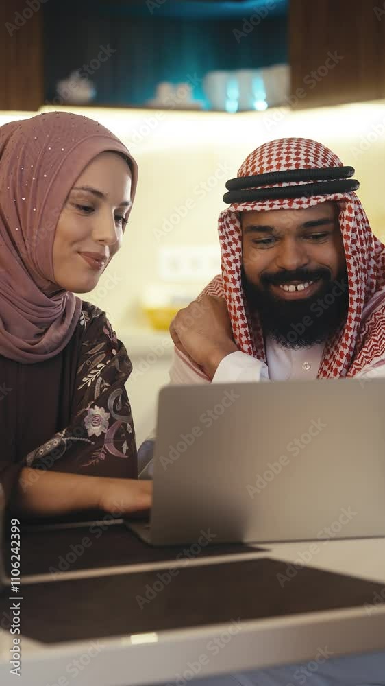 Muslim couple uses a laptop to choose a vacation destination and book tickets Muslim couple uses a laptop to choose a vacation destination and book tickets