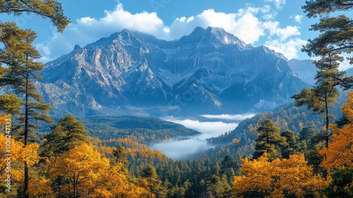 Scenic Mountain Range Framed by Lush Trees and Colorful Foliage