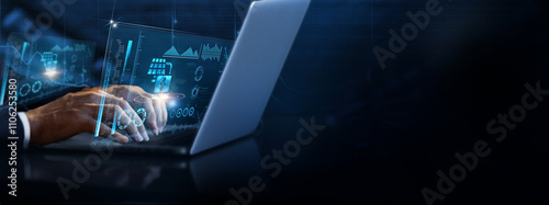 Energy Technology: Businessman using laptop and analyzing energy technology information on futuristic virtual interface screen, renewable energy, solar power, smart grids, energy efficiency. photo