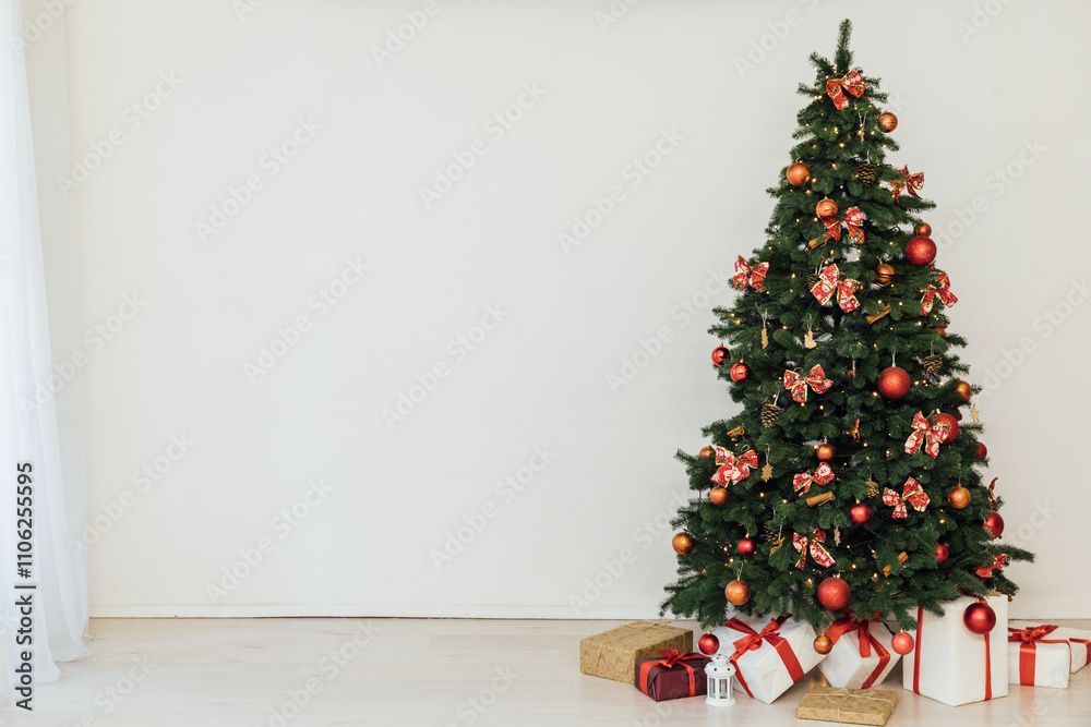 Christmas tree with gifts decorated with red toys lights garland in the interior for the new year Christmas tree with gifts decorated with red toys lights garland in the interior for the new year