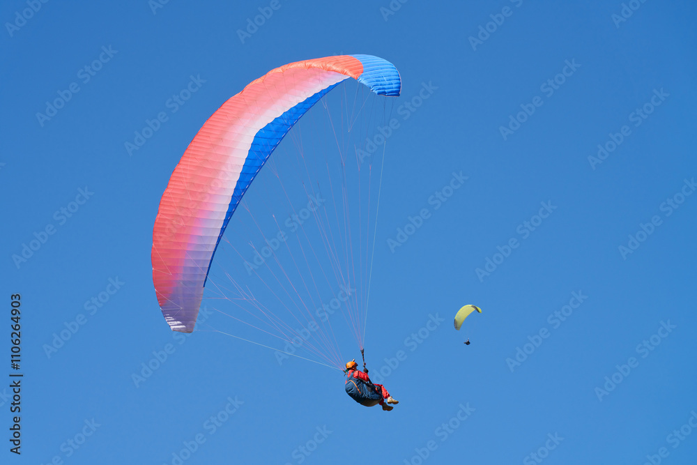 Paraglider under red dome against blue sky. Copy space. Paraglider under red dome against blue sky. Copy space.