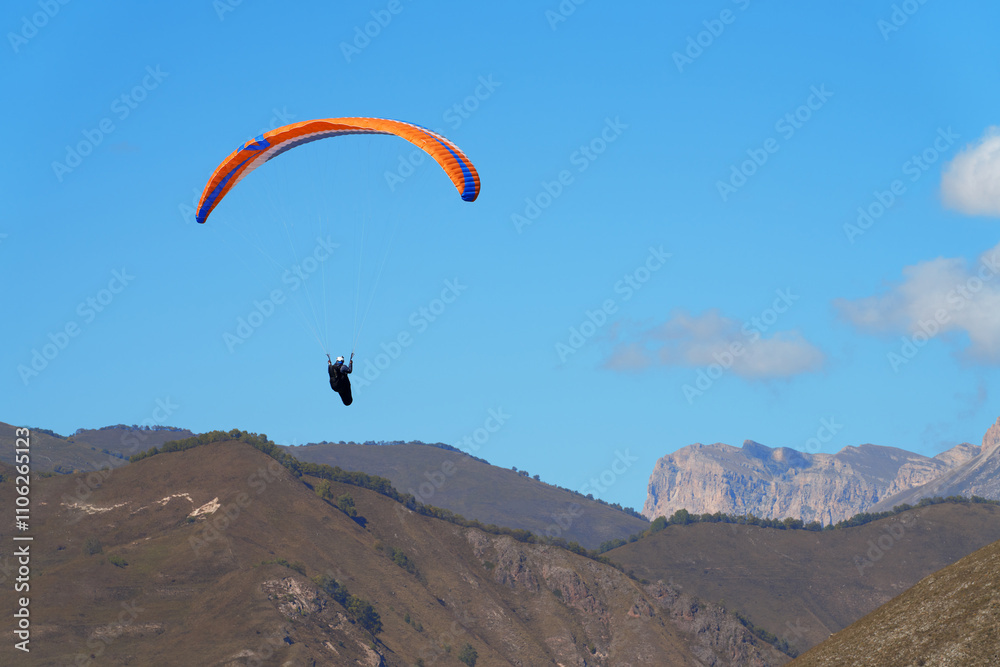 Flight of a paraglider in the rocky mountains. Chegem Aeroclub. Copy space. Flight of a paraglider in the rocky mountains. Chegem Aeroclub. Copy space.