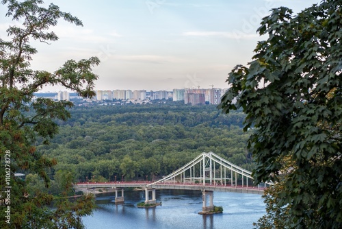 A Beautiful Scenic View of a River with a Bridge in a Lush and Vibrant Urban Landscape