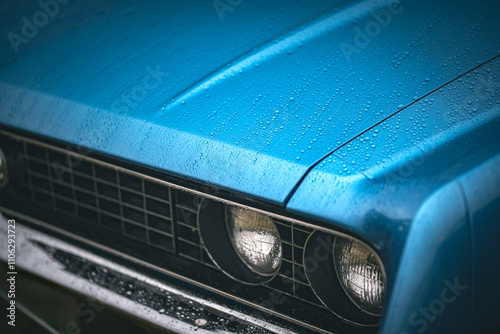 Close up view of a headlight and bonnet of a classic car. photo