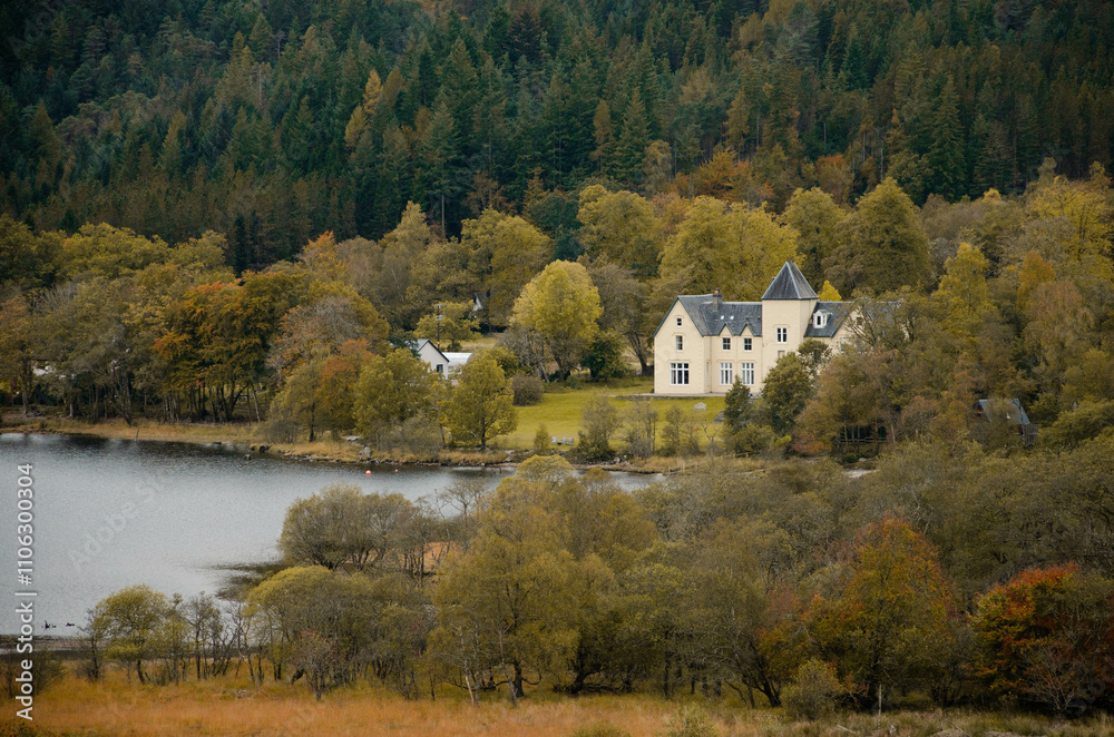 A picturesque house nestled beside the tranquil waters of Loch Shiel in the Scottish Highlands, surrounded by stunning natural beauty. The peaceful scene features the calm loch reflecting the A picturesque house nestled beside the tranquil waters of Loch Shiel in the Scottish Highlands, surrounded by stunning natural beauty. The peaceful scene features the calm loch reflecting the