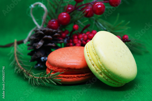 A spruce branch with a pine cone and multi-colored macaroons on a beautiful background, holiday, Christmas.