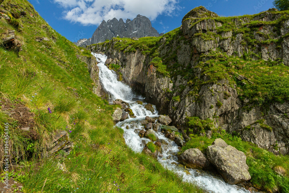 Hiking trail to Chaukhi mount from the village of Juta. Beautiful waterfall under Chaukhi. Chaukhistskhali river. Breathtaking landscape. Hiking trail to Chaukhi mount from the village of Juta. Beautiful waterfall under Chaukhi. Chaukhistskhali river. Breathtaking landscape.