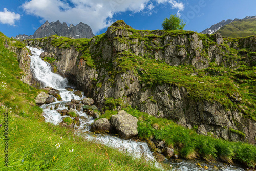 Hiking trail to Chaukhi mount from the village of Juta. Beautiful waterfall under Chaukhi. Chaukhistskhali river. Breathtaking landscape.