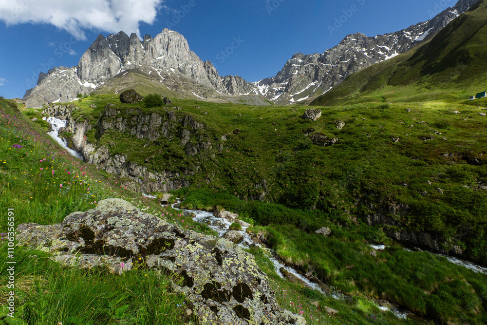 Hiking trail to Chaukhi mount from the village of Juta. Beautiful waterfall under Chaukhi. Chaukhistskhali river. Breathtaking landscape. Hiking trail to Chaukhi mount from the village of Juta. Beautiful waterfall under Chaukhi. Chaukhistskhali river. Breathtaking landscape.