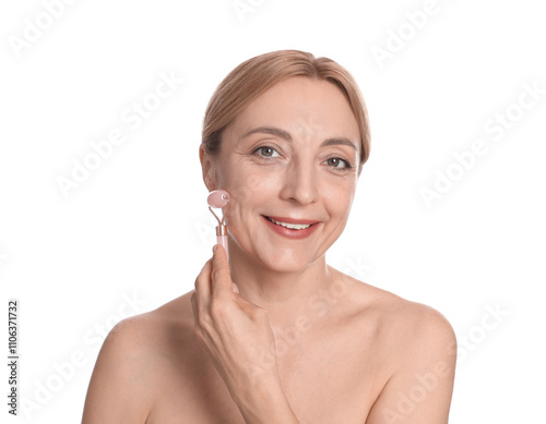 Smiling woman doing facial self massage with roller on white background