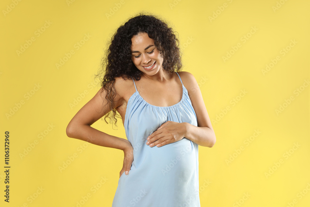Portrait of beautiful pregnant woman on yellow background Portrait of beautiful pregnant woman on yellow background