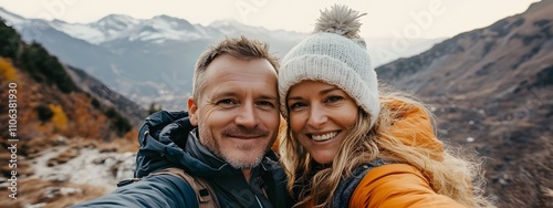 A middle-aged man with short blonde hair takes a selfie photo of himself and his wife