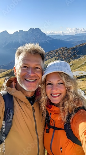 A middle-aged man with short blonde hair takes a selfie photo of himself and his wife