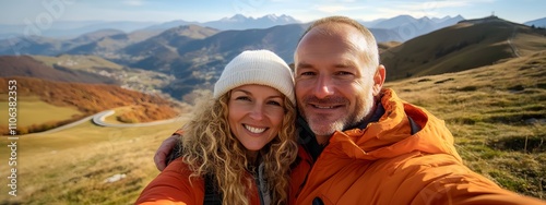 A middle-aged man with short blonde hair takes a selfie photo of himself and his wife