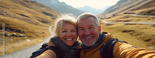 A middle-aged man with short blonde hair takes a selfie photo of himself and his wife