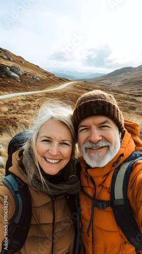 A middle-aged man with short blonde hair takes a selfie photo of himself and his wife