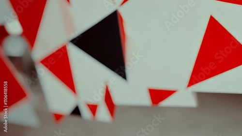 Bold red and black geometric triangle pattern with a soft gradient effect