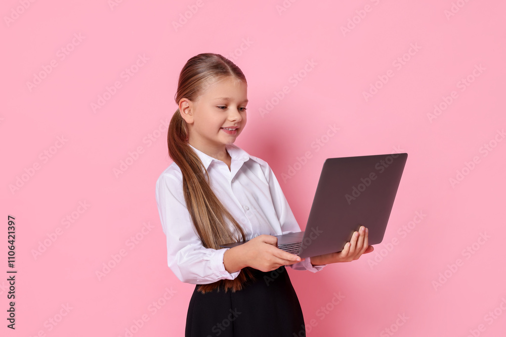 Little girl with laptop pretending to be accountant on pink background. Dreaming of future profession Little girl with laptop pretending to be accountant on pink background. Dreaming of future profession