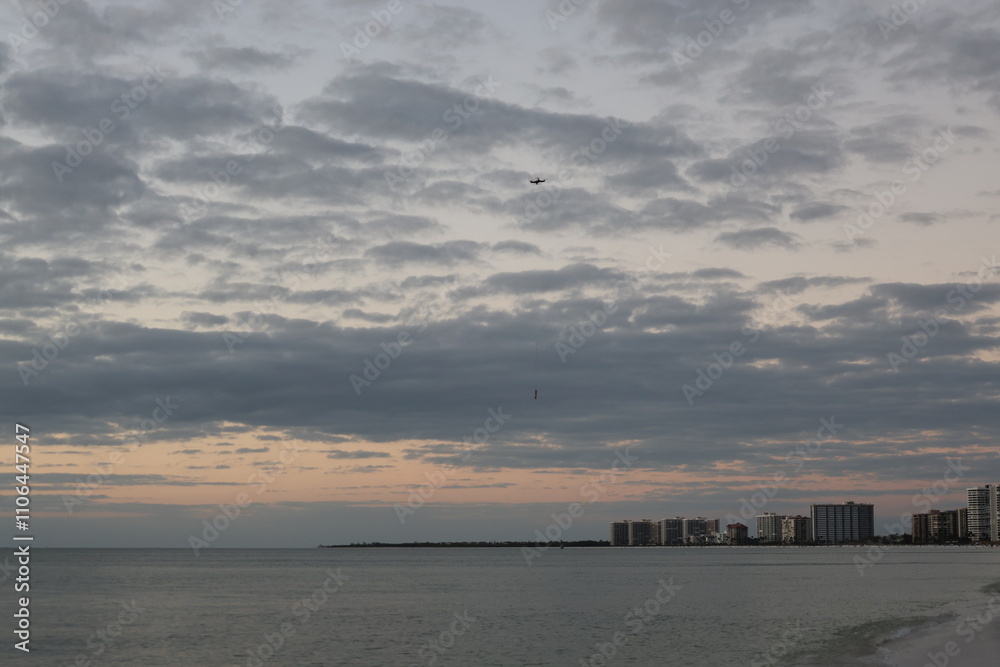 Sunset over the sea yellow sky dark clouds Sunset over the sea yellow sky dark clouds