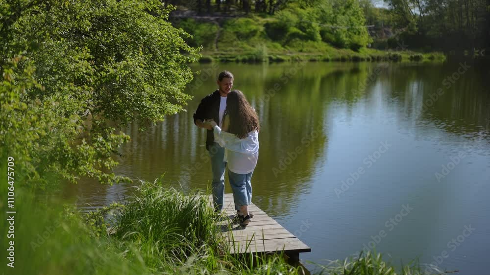 A couple enjoys the serene beauty of nature at a tranquil lake, creating cherished memories on a lovely dock A couple enjoys the serene beauty of nature at a tranquil lake, creating cherished memories on a lovely dock
