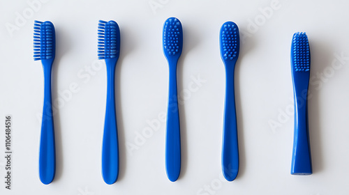 A blue plastic toothbrush captured in top view, sideways, and lengthwise orientations against a white background photo