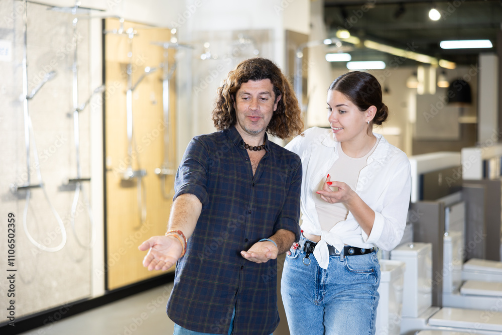 in hardware store in plumbing department, spouses calculates number of bathroom accessories necessary for purchase in hardware store in plumbing department, spouses calculates number of bathroom accessories necessary for purchase