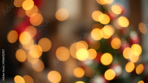 blurred Christmas background with decorated tree with red decorations and glistening golden lights