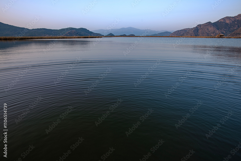 Fototapeta premium Ripples on the natural lake of the Dalyan river. On the delta of the river just before dusk 