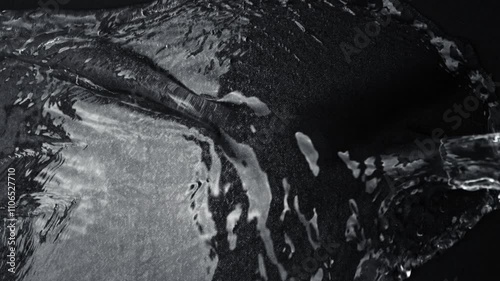 Super Slow Motion Detail Shot of Water Splashing on Waterproof Black Cloth at 1000fps. photo