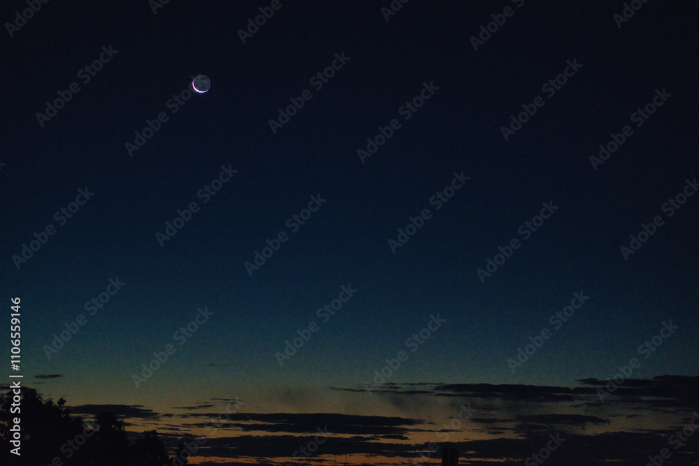 Tokyo,Japan - November 29, 2024: Waxing Crescent Moon with earthshine at winter dawn Tokyo,Japan - November 29, 2024: Waxing Crescent Moon with earthshine at winter dawn
