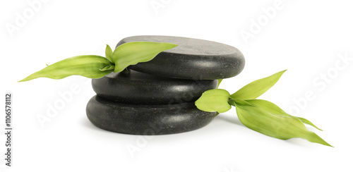 Spa stones and green leaves isolated on white