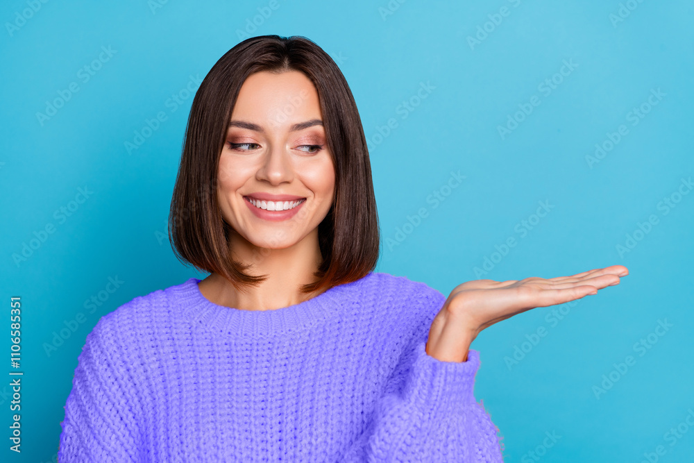 Portrait of attractive cheerful girl holding on palm copy space ad new solution isolated over bright blue color background Portrait of attractive cheerful girl holding on palm copy space ad new solution isolated over bright blue color background