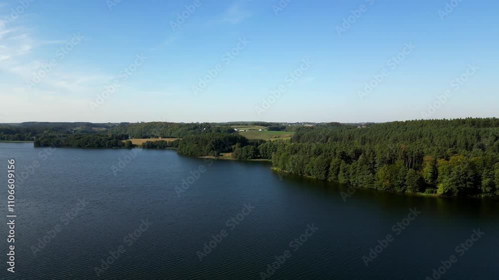 The blue sky and forest at the Radunskie Dolne lake. Aerial view, Kashubia, Poland. The blue sky and forest at the Radunskie Dolne lake. Aerial view, Kashubia, Poland.