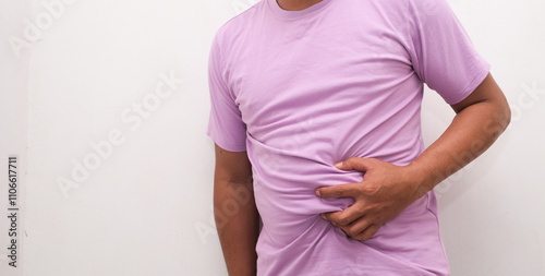 Wallpaper Mural The man is holding his stomach with his hand against the white background, indicating that he has stomach pain. Torontodigital.ca