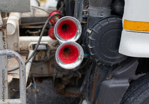 The red truck's air horn is mounted on the side.