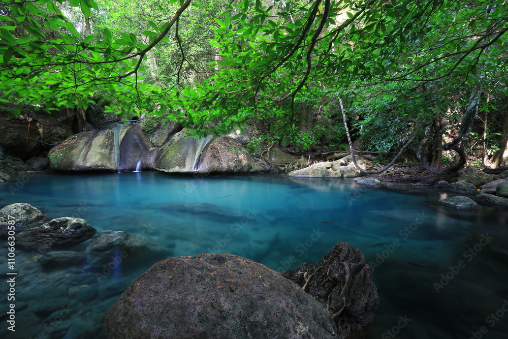 Fototapeta premium Tropical landscape waterfall with beautiful emerald lake and rocks in wild jungle forest. Erawan National park, Kanchanaburi Province, Thailand 