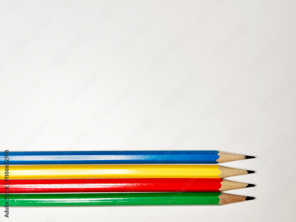 blue, yellow, red, and green pencils on a white background blue, yellow, red, and green pencils on a white background