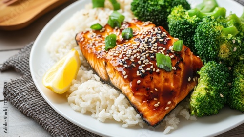 A mouthwatering plate of teriyaki salmon served with jasmine rice and steamed broccoli, Teriyaki salmon plated elegantly with sesame seeds sprinkled on top, Soy sauce drizzled for seasoning