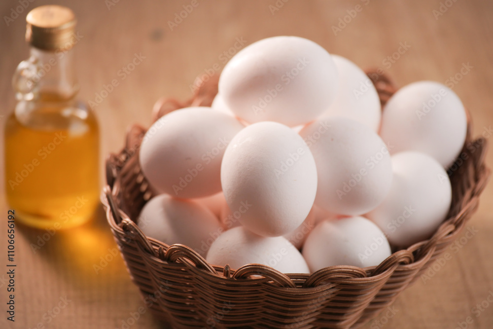 A Rustic Basket Filled with Fresh Eggs and Cooking Oil, Perfect for Culinary Delights A Rustic Basket Filled with Fresh Eggs and Cooking Oil, Perfect for Culinary Delights