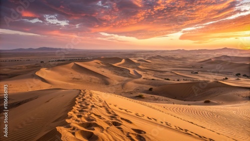 An expansive desert landscape under a vivid sunset the golden sand dunes undulating with intricate patterns as shadows stretch across the warm terrain. photo