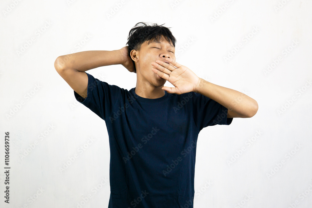Asian man with a sleepy expression and yawning with messy hair. Wake up concept. Isolated on white background. Asian man with a sleepy expression and yawning with messy hair. Wake up concept. Isolated on white background.