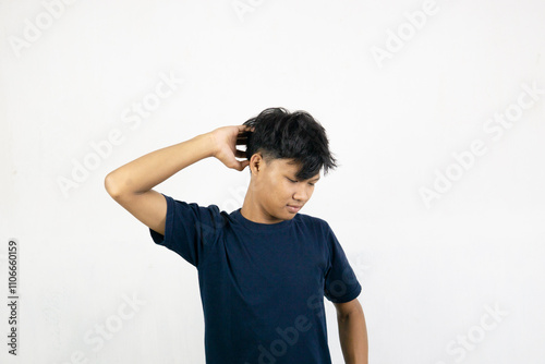 Asian man with sleepy expression with messy hair. Wake up concept. Isolated on white background