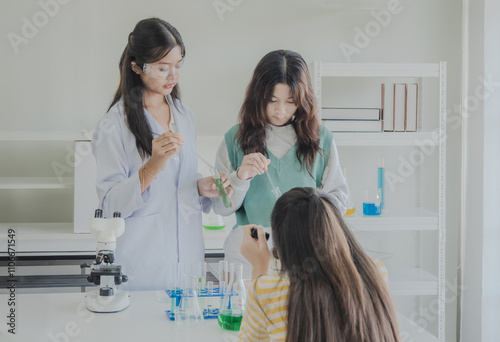 Child kid girl asian young student education tree people team group learning and smile have fun happy enjoy with science lab technology with in school classroom has tubetest microscope chemicals table photo