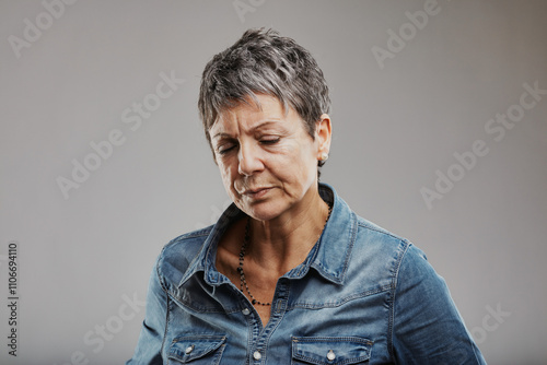 Mature woman feeling sad and disappointed, expressing negative e